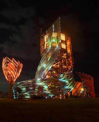 Tri Hita Karana tower seen in light with its twisting volume swirling upwards in bali