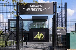 Merky FC HQ entrance gate, a black gate with signage on